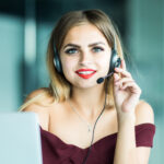Portrait of happy smiling woman customer support phone operator at workplace. Portrait of happy smiling female customer support phone operator at workplace.